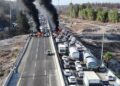 A drone photo shows protesters standing next to burning tires as they block Israel's main highway connecting Jerusalem and Tel Aviv near Latrun, Israel, after families of hostages have called for a nationwide strike to demand the return of all hostages and an end to the war in Gaza, August 17, 2025. REUTERS/Stringer