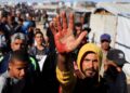 A Palestinian man shows blood stains on his palm after he carried casualties among people seeking aid supplies from the U.S.-backed Gaza Humanitarian Foundation, in Khan Younis, in the southern Gaza Strip, May 29, 2025. REUTERS/Hatem Khaled     TPX IMAGES OF THE DAY