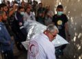 One of the bodies of staff members of the US-based aid group World Central Kitchen, is transported out of a hospital morgue in Rafah in the southern Gaza Strip on April 3, 2024, two days after a convoy of the NGO was hit in an Israeli strike as battles continue between Israel and the Palestinian militant group Hamas. - The bodies of six foreign aid workers killed in a Gaza strike were expected to be transported out of the war-torn Palestinian territory on April 3, as Israel faced a chorus of outrage over their deaths. (Photo by SAID KHATIB / AFP)