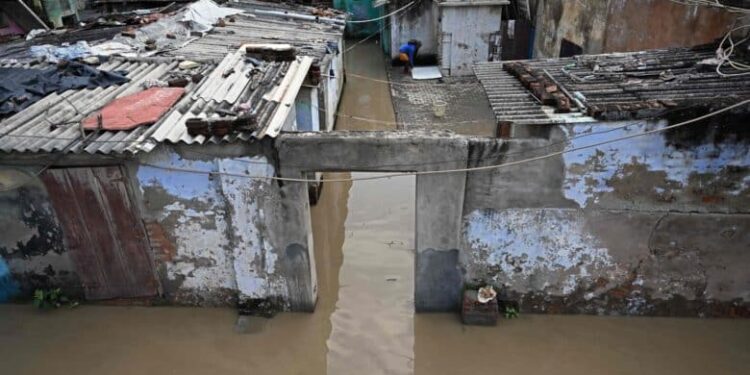 A general view shows houses inundated near banks of overflowing river Yamuna, after heavy monsoon rains in New Delhi on August 19, 2025. (Photo by Sajjad HUSSAIN / AFP)